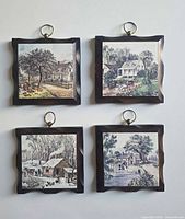 Front view of four framed ceramic tile plaques showing all scenes