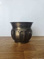 Front view of brass fluted planter pot