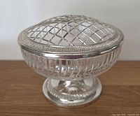 Overall view of glass rose bowl with silver-plated lattice lid