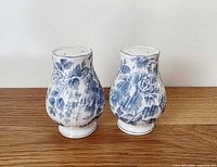 Front view of both shakers displaying floral pattern and shape