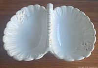 Top view showing twin compartments, scalloped rim, handle, gilt accents