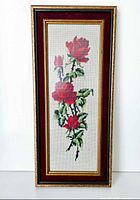 Front view of framed rose needlepoint wall art