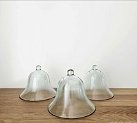 All three glass cloches grouped on tabletop