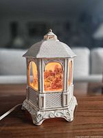 Front view of white porcelain gazebo lamp illuminated