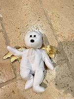 Front view of Ty Halo II angel bear Beanie Baby showing white plush body, gold wings and halo