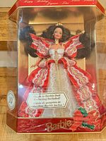 Front of sealed 10th Anniversary Happy Holidays Barbie box showing doll in red and gold gown
