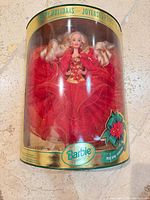 Front of sealed Happy Holidays Barbie box showing doll in red gown