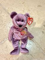Front view of purple speckled Ty 2000 Signature Bear with swing tag
