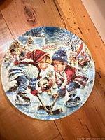 Front of decorative plate showing winter hockey scene