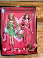 Front view of unopened Juicy Couture Barbie Collector boxed set showing two dolls and accessories