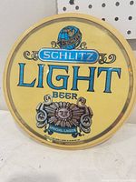 Front view of circular Schlitz Light Beer sign