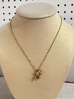 Full view of necklace on bust displaying chain length and pendant