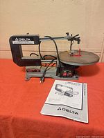 Full view of Delta scroll saw with manual and power cord