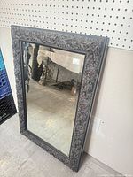 Full view of mirror showing carved frame and overall shape