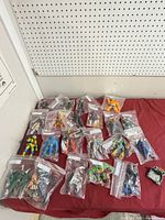 Overall view of all bagged action figures laid out (approx. 18 bags)