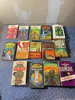 Top and mid rows showing multiple Heinlein coloured-bar editions and Asimov Foundation paperback