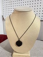 Necklace displayed on bust form