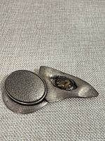 Full view of abstract silver-tone brooch