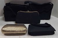 Group of five evening purses, four black, one gold