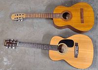 Full view of both acoustic guitars showing overall condition