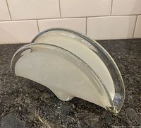 Murano style glass napkin holder left side view showing clear and white layers