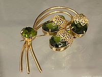 Full view of brooch showing branch shape and three acorn stones