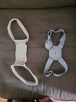 Overhead view of two posture correctors, grey and beige models