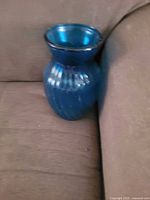 Full view of blue ribbed glass vase upright