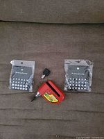 Overall lot showing brake lock, keys, two earring packs