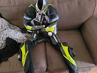 Front view of leather racing suit laid on sofa