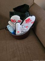 Stock pot containing lunch bag, oven mitts, ice block