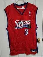Front view of red Allen Iverson #3 Philadelphia 76ers jersey hanging