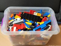open bin showing assorted LEGO bricks of multiple colors