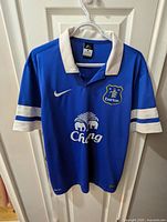 Front view of blue Everton Nike jersey showing crest, sponsor, collar, sleeve details