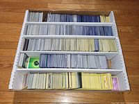 Top view of five-row box filled with Pokémon cards