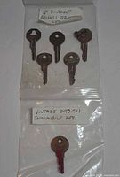 Six vintage keys in two labelled plastic bags