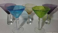 Front view of six coloured martini glasses showing bowl colours and stems