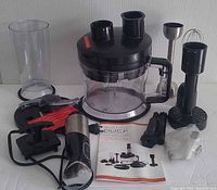 complete set laid out including bowl, lid, motor, attachments, manual