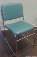 Front angled view of aqua faux leather armless chair