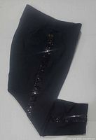 Pants folded to show sequin stripe and ankle detail