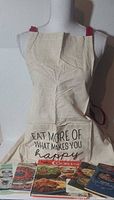 Apron displayed on mannequin with cookbooks arranged below