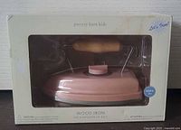 Boxed pink wooden toy iron in packaging showing brand and product name