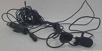 Full view of tangled dual lavalier microphone set with clips and windscreens