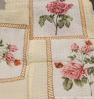 Close view of duvet and sham fabric showing floral design, rope border, and texture