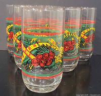 Six identical Christmas print glass tumblers grouped