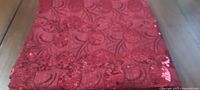 Folded red sequin tablecloth overview