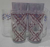 All seven glasses grouped: lattice front, floral and purple in back