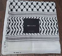 Folded keffiyeh showing overall pattern and KUVRD tag
