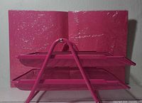 Two-tier fuchsia tray positioned before unopened pack of fuchsia envelopes