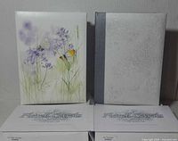 Front view of both guest books with packaging